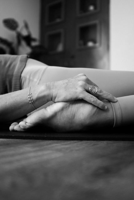 Close-up of hands resting on the body during relaxation, black and white