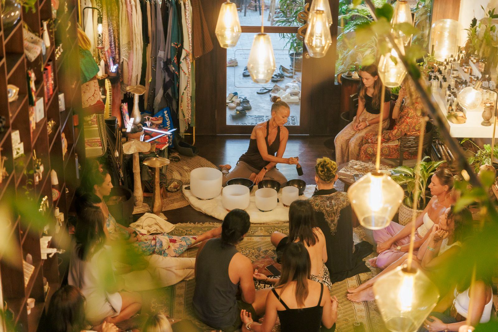 A group seated around crystal bowls in candlelight