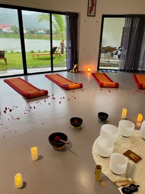 Candles, singing bowls and mats prepared for an evening sound bath